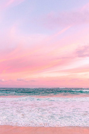Pastel Pink Beach Sunset with Gentle Waves and Soft Ocean Horizon HD phone wallpaper