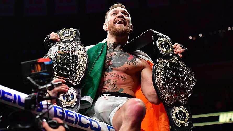 Conor McGregor Celebrating Victory With UFC Championship Belts And Irish Flag HD wallpaper