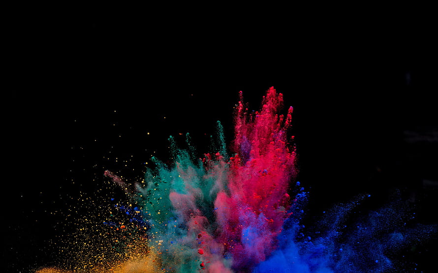 Vibrant Multicolored Powder Explosion Bursting Against a Pitch Black Background HD wallpaper