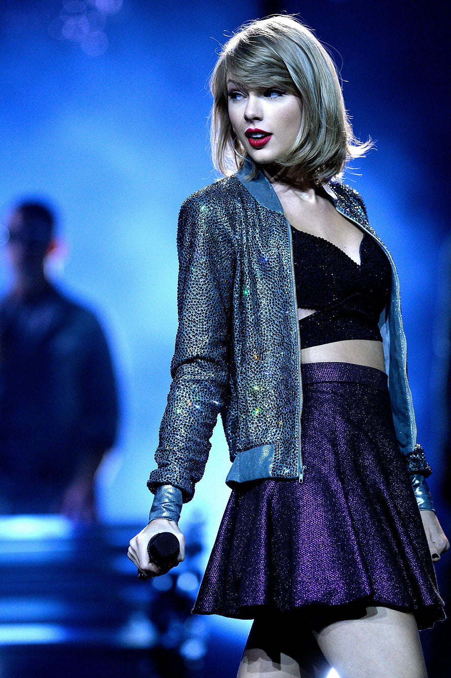 Taylor Swift performing on stage in a sparkly jacket and purple skirt HD phone wallpaper