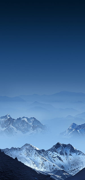 Layered Snow-Capped Mountain Ranges in Blue Mist and Clear Sky HD phone wallpaper
