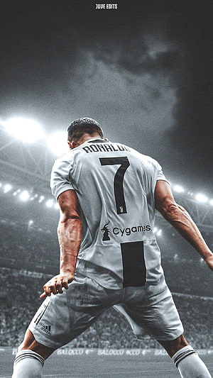 Cristiano Ronaldo in Juventus Kit Walking on the Pitch Under Stadium Lights HD phone wallpaper