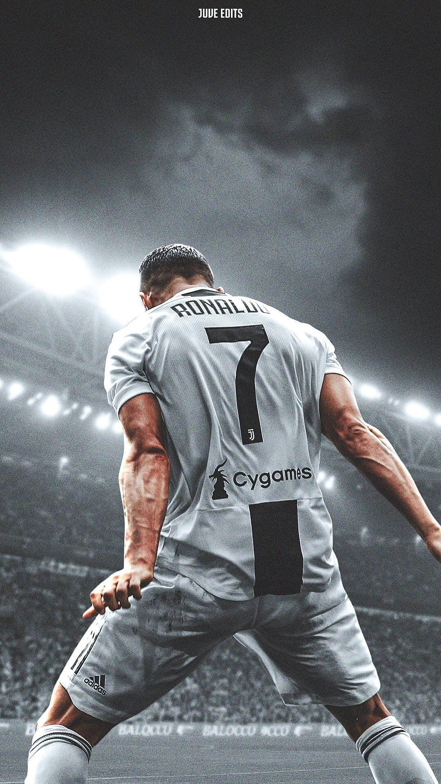 Cristiano Ronaldo in Juventus Kit Walking on the Pitch Under Stadium Lights HD phone wallpaper