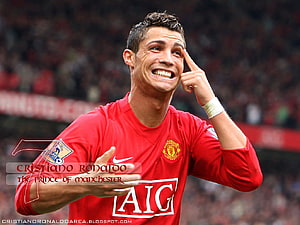 Cristiano Ronaldo in Manchester United Red Kit Pointing to Temple in Stadium HD wallpaper
