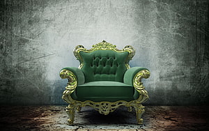 Ornate Green Velvet Armchair with Gold Baroque Carvings Against Textured Concrete Wall HD wallpaper
