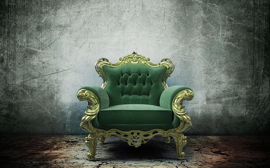 Ornate Green Velvet Armchair with Gold Baroque Carvings Against Textured Concrete Wall HD wallpaper