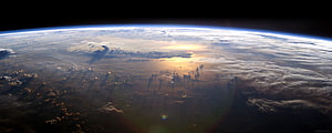 Earth From Space At Sunset With Atmospheric Glow And Cloud Cover HD wallpaper