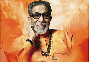 Portrait of Indian Music Legend Bappi Lahiri Wearing Orange Kurta and Sunglasses HD wallpaper
