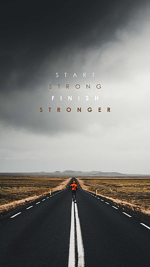 Lone Runner on Endless Road Under Stormy Sky with Motivational Quote HD phone wallpaper