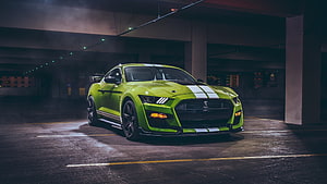 Green Ford Mustang Shelby GT500 with Racing Stripes in a Dark Underground Parking Garage HD wallpaper