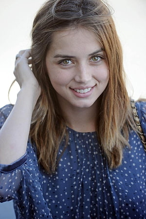 Ana de Armas smiling portrait in a blue star-patterned blouse with soft natural lighting HD phone wallpaper