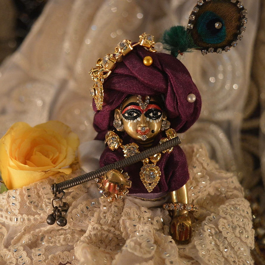 Laddu Gopal Krishna Idol with Maroon Turban, Peacock Feather, and Gold Jewelry HD wallpaper