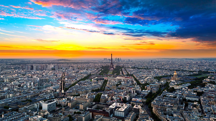 Aerial View of Paris at Sunset with the Eiffel Tower and Cityscape Under a Vibrant Sky HD wallpaper