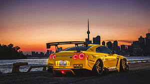 Yellow Nissan GT-R R35 Widebody with HKS and Bride Stickers Parked at Sunset in Toronto HD wallpaper