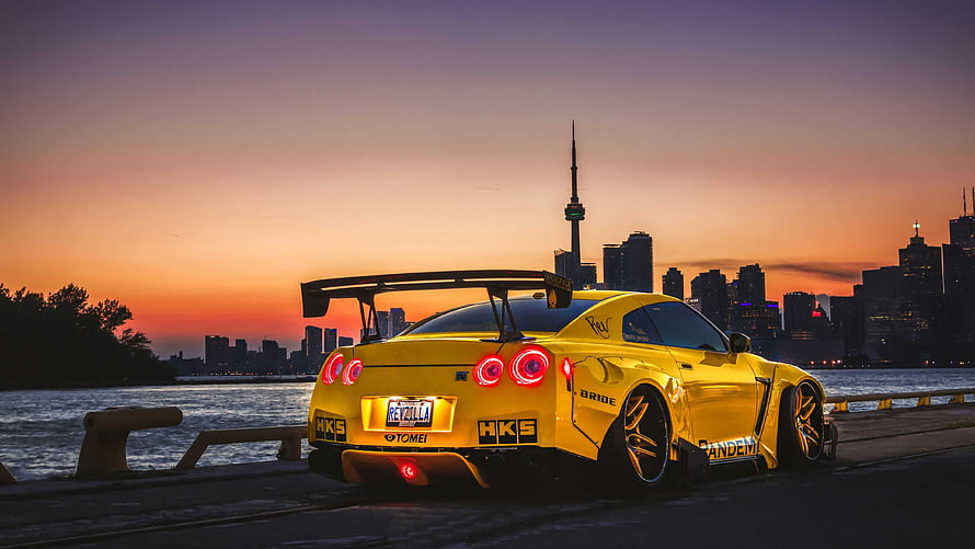 Yellow Nissan GT-R R35 Widebody with HKS and Bride Stickers Parked at Sunset in Toronto HD wallpaper