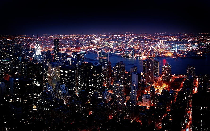 New York City skyline at night with illuminated skyscrapers and the East River HD wallpaper