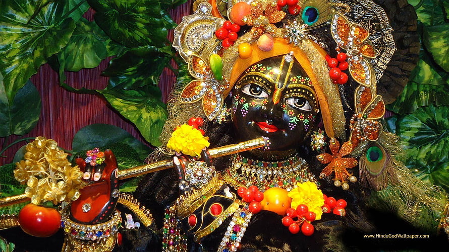Ornate Black Krishna Idol Playing Flute with Peacock Feathers and Floral Jewelry HD wallpaper