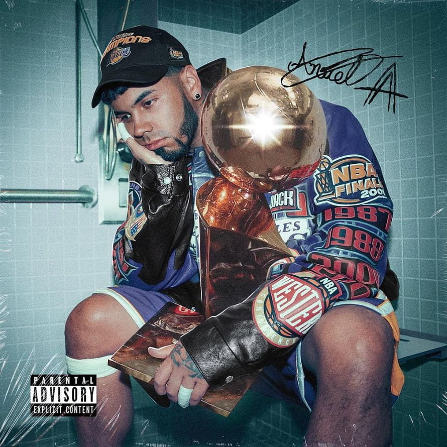 Anuel AA holding NBA trophy in bathroom wearing Lakers jersey and cap HD phone wallpaper