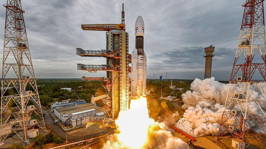 ISRO GSLV Mk III rocket launch with bright exhaust plume and launch tower HD wallpaper
