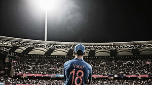 Virat Kohli Cricket Player Standing In Stadium Under Floodlights HD wallpaper