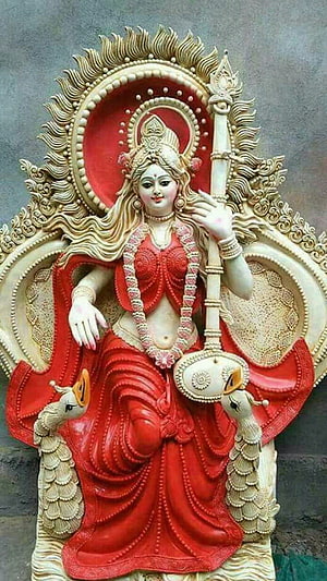 Saraswati Maa Murti in Red Saree with Veena and Peacocks HD phone wallpaper