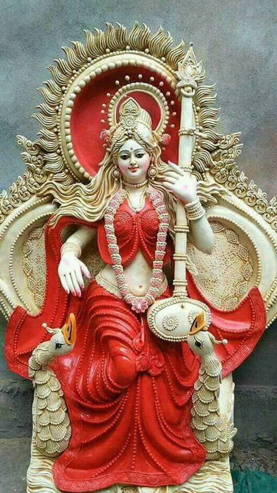 Saraswati Maa Murti in Red Saree with Veena and Peacocks HD phone wallpaper