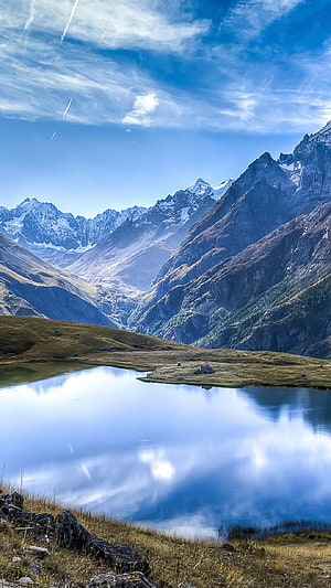 Alpine Mountain Lake with Snow-Capped Peaks and Mirror Reflection Under Blue Sky HD phone wallpaper