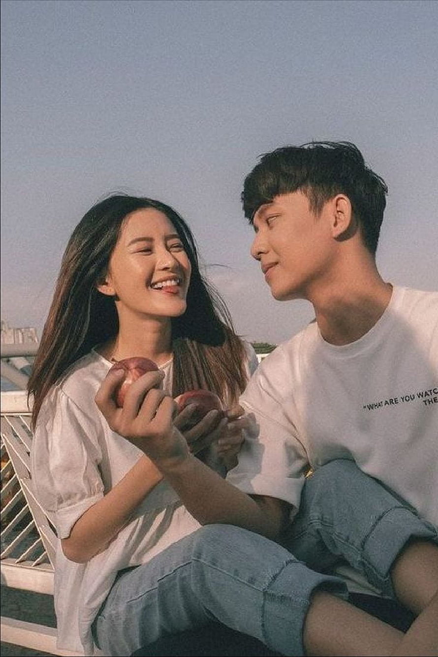 Korean Couple Sharing Apples in Soft Golden Hour Light HD phone wallpaper