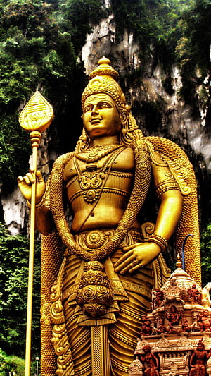 Giant Golden Murugan Statue at Batu Caves with Vandy and Lush Greenery HD phone wallpaper