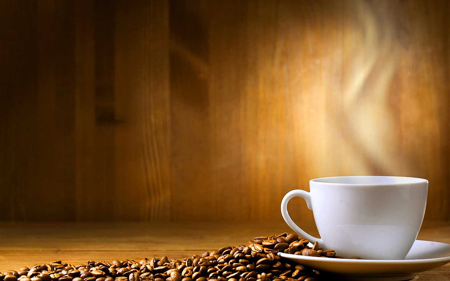 Steaming White Coffee Cup with Roasted Beans on Warm Wooden Table HD wallpaper