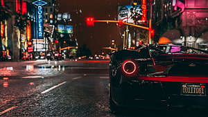 Black Lamborghini Huracan on Rainy Neon City Street at Night HD wallpaper